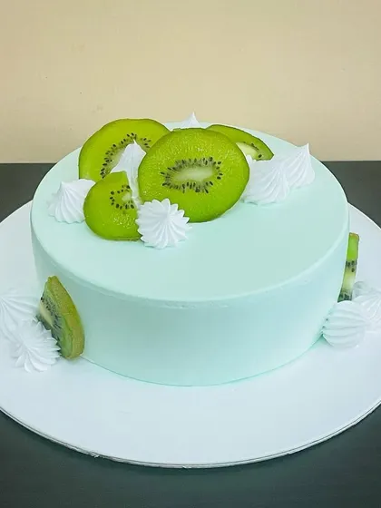 A vibrant and refreshing Kiwi Cake. The light green frosting and fresh kiwi slices make it a light and fruity dessert option.