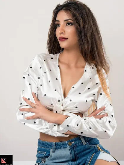 A confident pose with arms crossed from the 'Polka Dots' series. This shot emphasizes the model's attitude and the stylish contrast between the satin top and denim.
