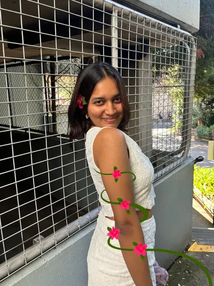 A simple photo in a white outfit, with a vine of pink flowers doodled around my arm.