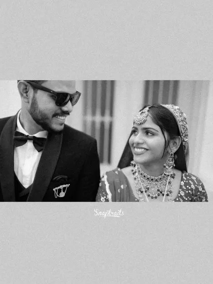 A classic black and white portrait of the couple, highlighting their expressions and the timeless elegance of their wedding attire.