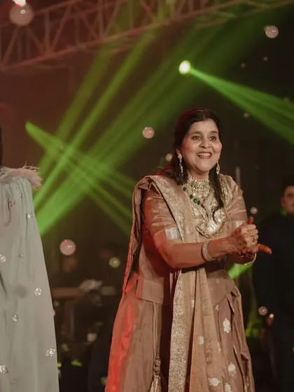 The mothers of the bride and groom enjoying their moment on stage. Their happy expressions show the joy of two families coming together.