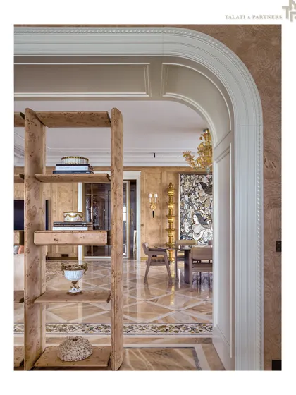 An arched doorway frames a view into a room with intricate marble flooring and classic architectural details. This image is from one of our projects featured in Architectural Digest's prestigious AD100 list, recognizing our firm's legacy of design excellence.