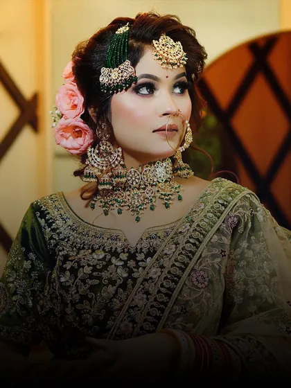 A beautiful close-up of a bride in a green velvet lehenga. The color is unique and perfect for a bride who wants to try something different.