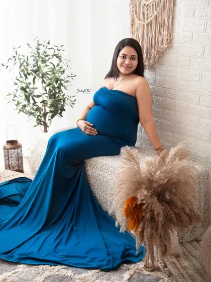 This mama looks so elegant and peaceful in a simple blue tube gown. The boho elements like pampas grass and the woven bench add texture and warmth to her solo portrait.
