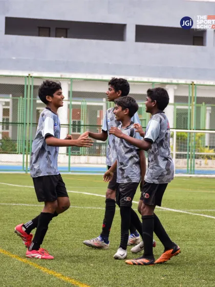 Teammates celebrate a successful play, highlighting the camaraderie and positive reinforcement that are central to our team culture.