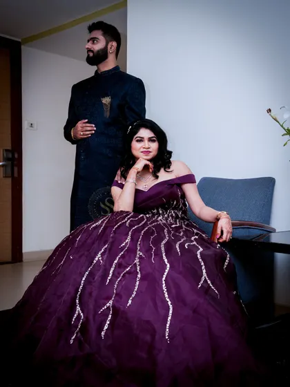 A classic couple portrait taken indoors. We arranged this shot to have a formal, yet relaxed feel, showcasing their coordinated outfits and the elegance of the occasion.