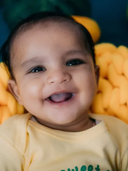 As sweet as a mango! This 4-month-old's happy smile is absolutely contagious. Fruit-themed shoots are a fun way to celebrate a milestone.