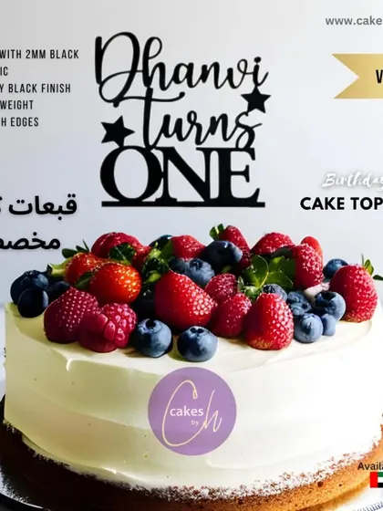 This fresh fruit cake is a popular choice, featuring strawberries, blueberries, and raspberries over a smooth cream cheese frosting. Here it is again, personalized for Dhanvi's first birthday with a bold, black topper.