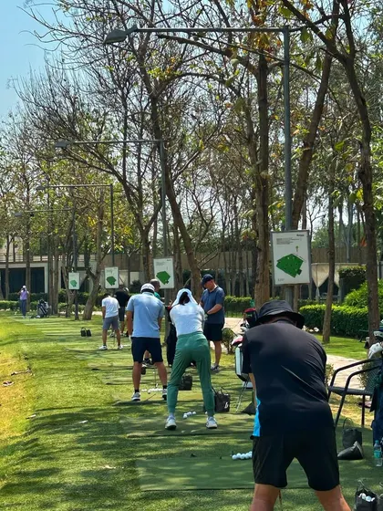 Sun's out, game face on. A busy driving range on a bright and sunny day.
