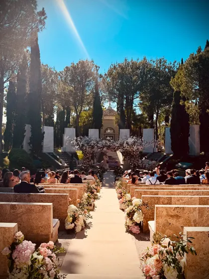 The stunning outdoor amphitheater ceremony setup for Caroline and Kabir's wedding in Marbella, Spain. The blend of natural beauty and elegant floral design created a truly romantic atmosphere.