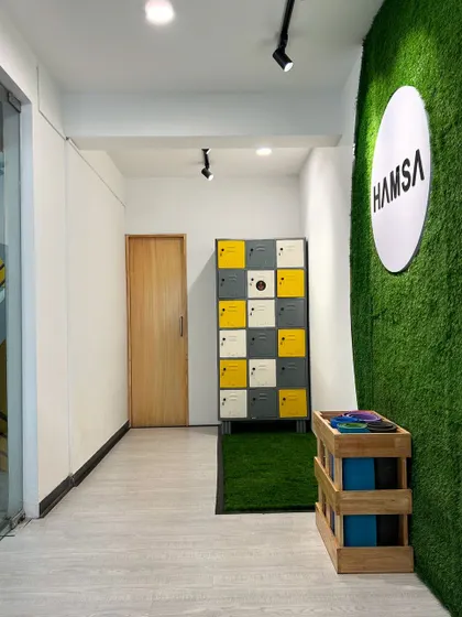 The entrance to our Hamsa Learning Centre, complete with lockers for your convenience. The green wall and clean design welcome you into a space of focus and growth.