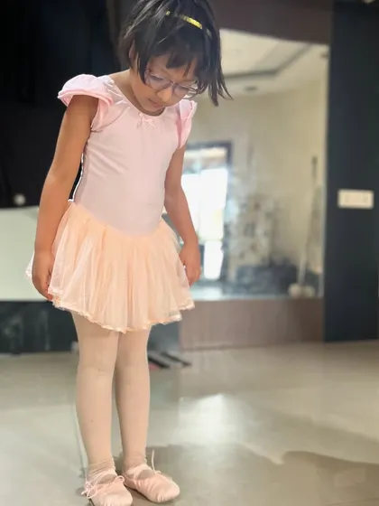 A young ballerina learns basic positions and stretches. My kids' ballet classes are designed to introduce the fundamentals of ballet in a gentle and encouraging way.