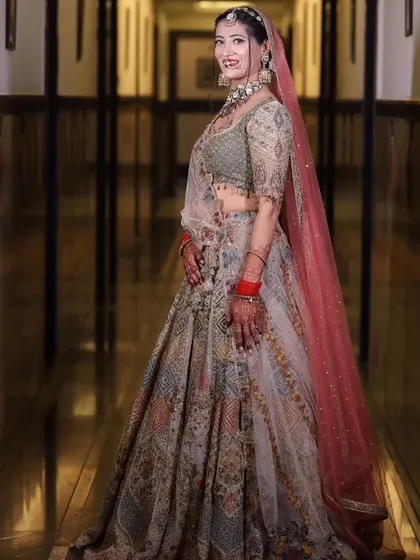 A side profile of the bride, highlighting the elegant way her dupatta is draped and her joyful expression.