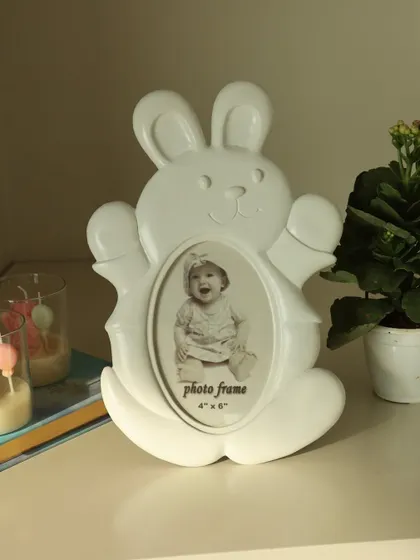 The playful white bunny photo frame, designed to bring a sense of joy and innocence to your child's room. Its clean and simple design fits beautifully in any nursery decor.