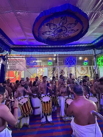 A wide view of our Panchari Melam performance under the vibrant lights of the temple, led by the esteemed Shri Peruvanam Sankaranarayanan Marar.