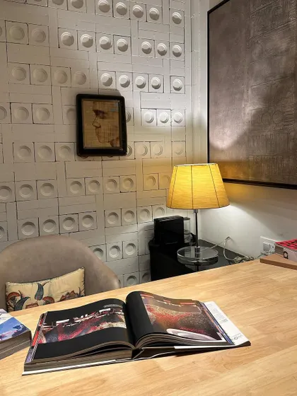 My personal desk space. I believe your surroundings affect your mood, so I love how this painting by Sunil Padwal blends with the earthy vibes of the textured wall and warm wood desk, creating a calming and inspiring place to work.