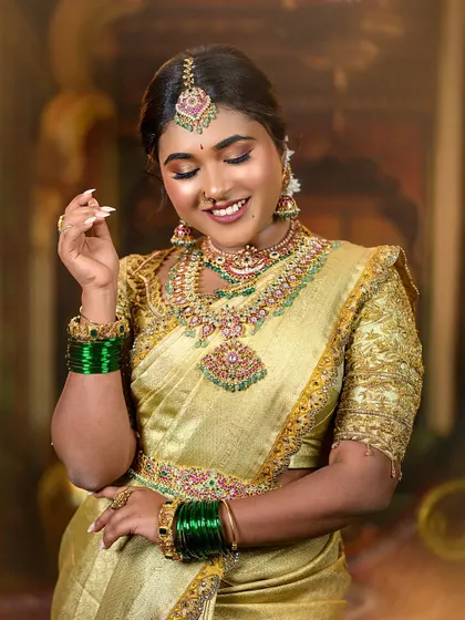 A joyful shot of the bride smiling, showing how the makeup looks natural and beautiful even in motion. The green bangles add a lovely pop of color.