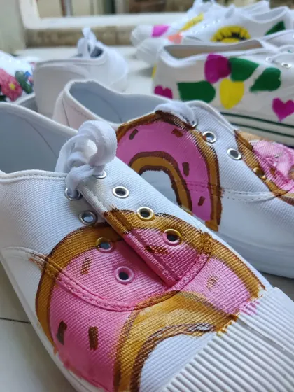 A detailed look at a donut-themed sneaker painted by a participant. I provide all the guidance and materials to help you turn a simple idea into a cool, wearable design.