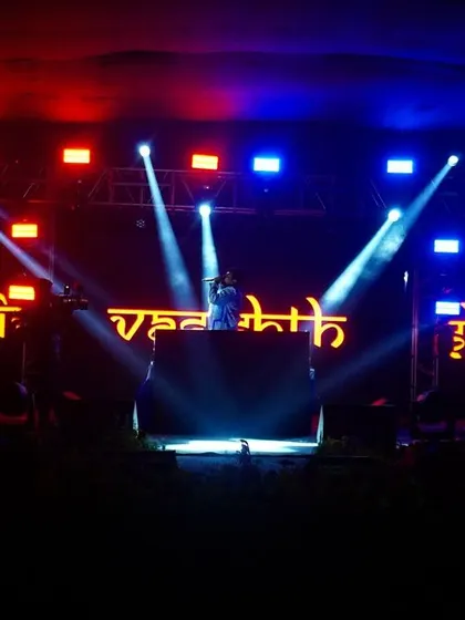 On a massive stage with my name lit up on the LED screen. This image showcases my branding and the professional level of my solo shows.