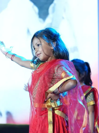 A graceful dance performance in beautiful red sarees, showcasing traditional movements.