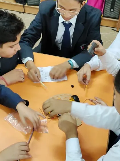 Students from Lions Public School work together as a team, fully engaged in building their first robot during our workshop.
