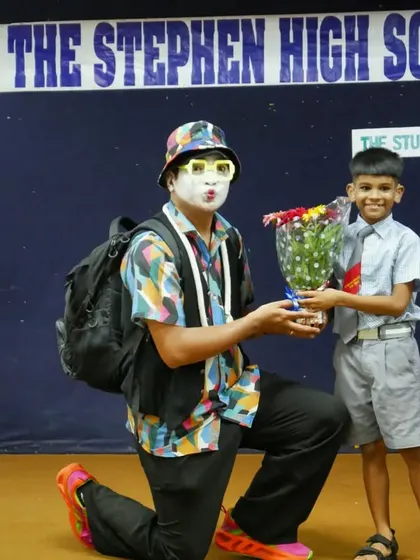 A young boy presents a bouquet of flowers to the 'Silent Storyteller'. This gesture of gratitude shows the deep impact these special sessions have on the children.