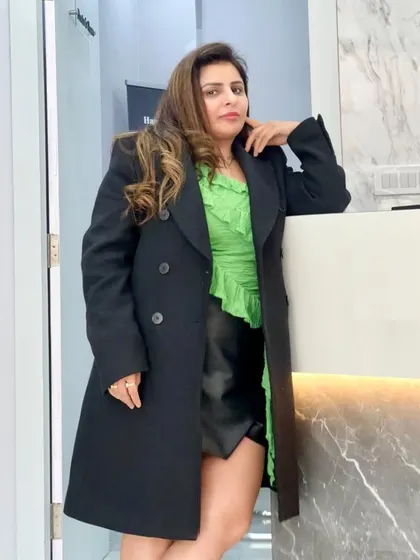 Our founder, Dr. Ritu, embodying the confidence and style we aim to inspire in all our clients.