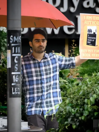 An author selling his own book on the street. This image is about hustle and passion, capturing the dedication it takes to pursue a dream.