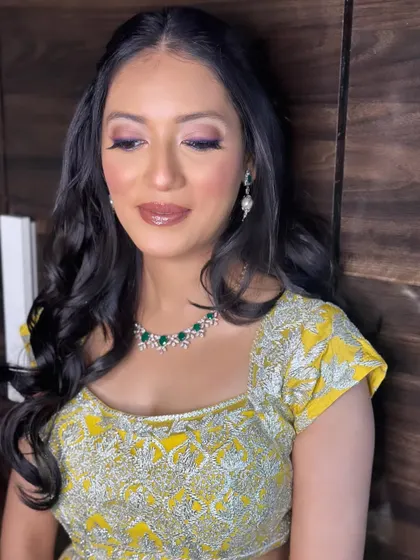 The focus here is on the glowing skin and the beautifully blended eye makeup. This is a perfect look for a Mehendi or Haldi ceremony.