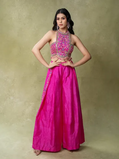 A confident, full-length pose in a vibrant pink ethnic outfit. The studio lighting ensures the colors are bright and true to life.