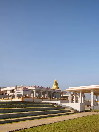 The tiered landscaping in the foreground is an integral part of the visitor's journey, creating a gradual approach to the main temple structure and respecting the natural feel of the site.