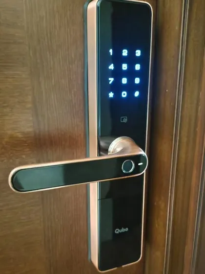 This is a close-up of the Qubo smart lock, highlighting the fingerprint sensor conveniently placed on the handle for ergonomic and intuitive unlocking.