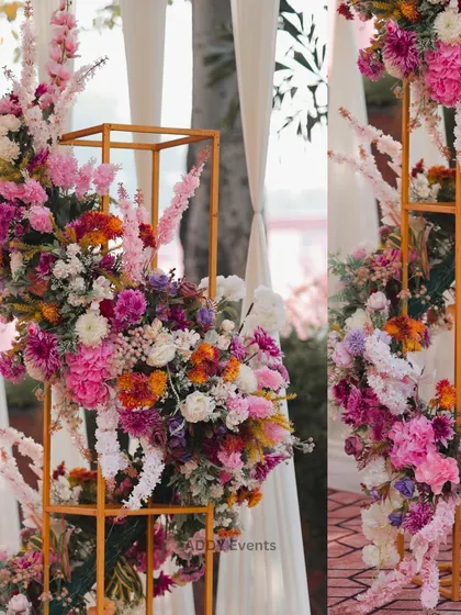 We use modern art-like structures to display flowers in a unique way. These golden metal frames with cascading arrangements of colorful blooms act as beautiful decorative pillars for an entrance or stage.