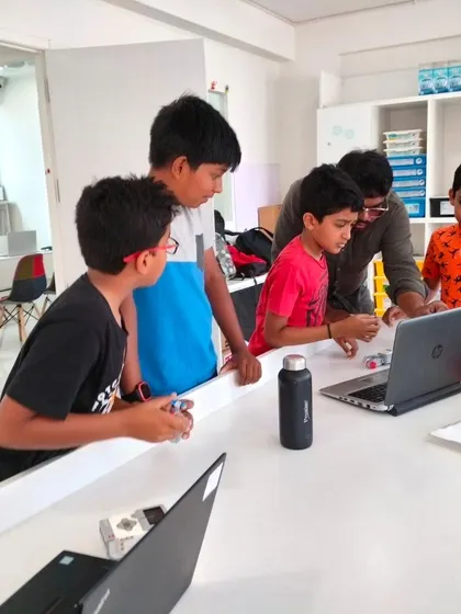 A team of students collaborates with their instructor during our summer camp. This small group setting ensures every child gets the attention they need to succeed.