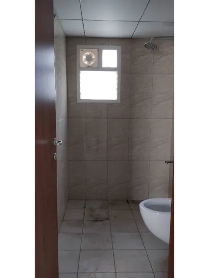 Before: The guest bathroom in the JWD Marq Home was a simple, functional space with standard tile work, ready for a complete design overhaul.