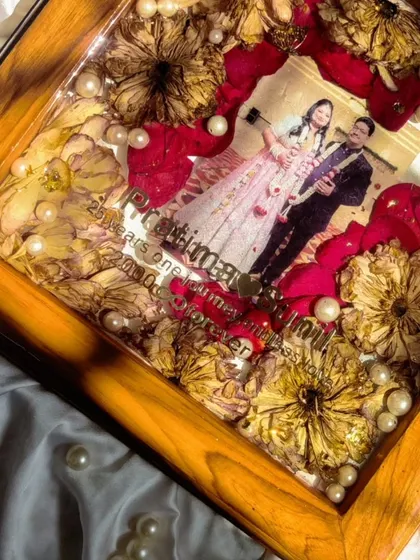 25 years of love, preserved forever. This square teakwood frame, filled with the couple's anniversary varmala, is a beautiful way to celebrate a silver jubilee and honor a lifetime of memories.