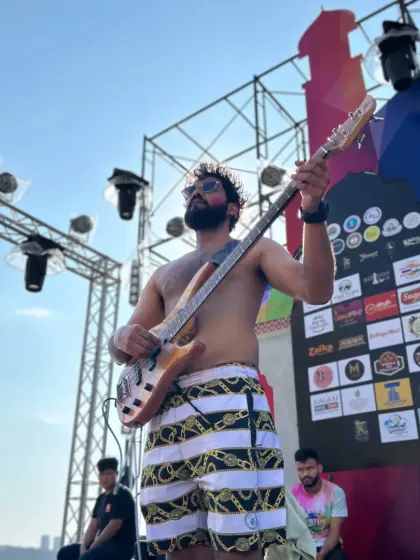 Sun, sand, and rock and roll. Our bassist enjoying the outdoor stage during the Grand Holi Festival in Pattaya, Thailand.