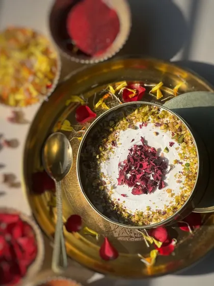 An overhead shot of my Thandai Tres Leches, a perfect dessert for Holi. It's a light, milky cake infused with the traditional flavours of thandai and garnished with pistachios and rose petals.