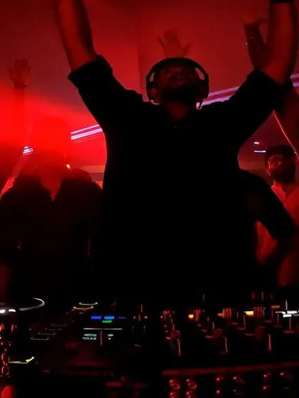 Hands in the air, celebrating a massive track with the crowd right in front of me. The energy in a boiler room setup is electric.
