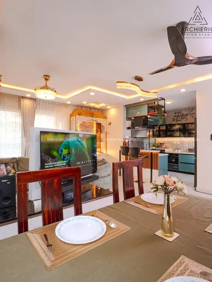 This image captures the view from the dining table towards the living area, showcasing the innovative rotating TV unit that serves both spaces.