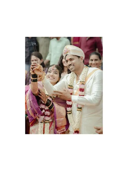 A happy, candid moment from a Hindu wedding ceremony, with the couple celebrating with sparklers.