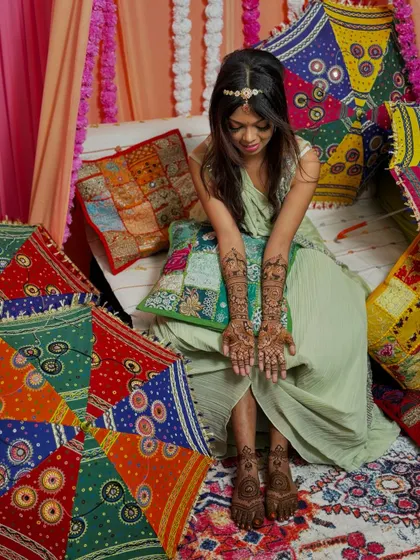 The full bridal mehendi look, with detailed designs on both hands and feet, perfectly complementing the festive atmosphere.