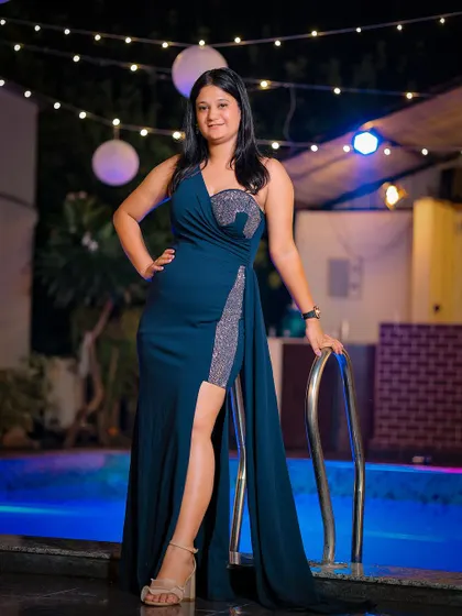 A full-length portrait by the pool, showcasing the guest's elegant evening wear.