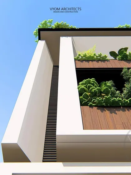 A detail shot of the upper floor of the Dasharatha residence, showing the deep-set balcony with integrated planters. This brings greenery to the facade and enhances the building's simple, elegant form.