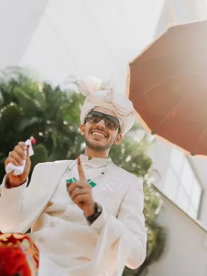 The groom's joyful and energetic arrival at the wedding venue, ready for the celebrations to begin.