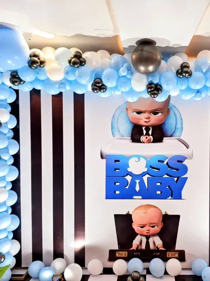 The backdrop for Jeyden's party, featuring a balloon arch over a black-and-white striped background with the Boss Baby logo.