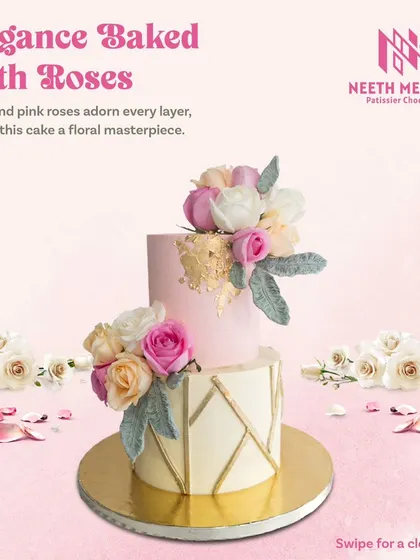Elegance baked with roses. This two-tiered cake features a geometric pattern on the bottom and is adorned with beautiful white and pink roses.