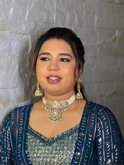 This client looks stunning in the rented pearl choker set, pairing it with a modern blue indo-western outfit for a chic and stylish party look.