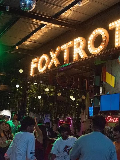 The iconic 'Foxtrot' sign glowing above a lively dance floor. I love playing at venues with a unique character and vibe.