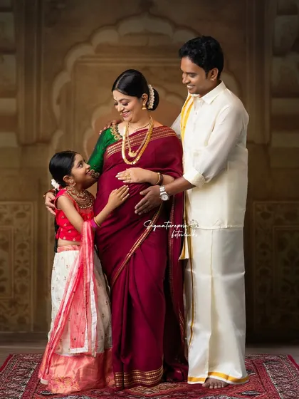 A full family portrait taken during a traditional maternity session, celebrating the growing family in an elegant and timeless style.